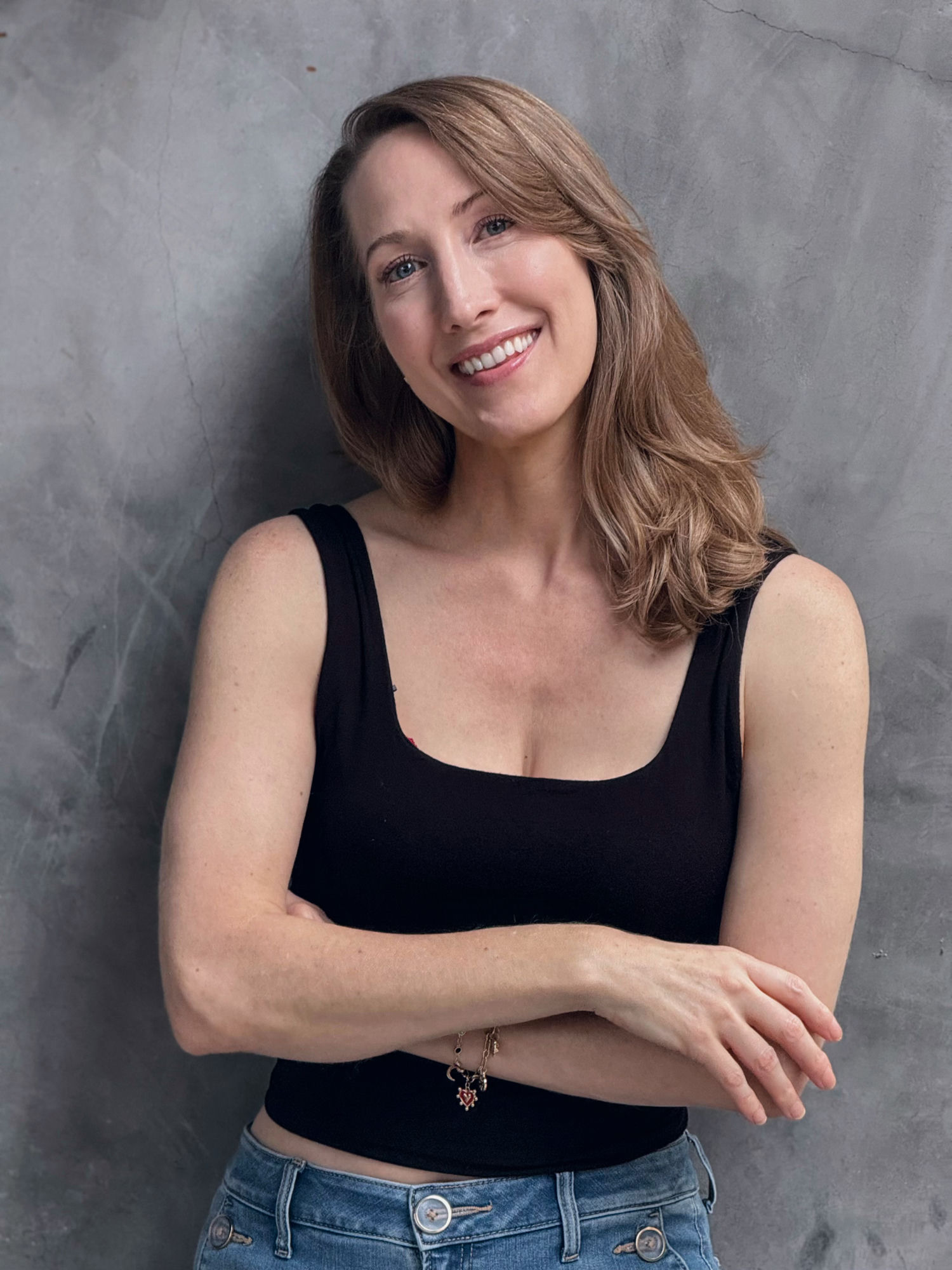 Erin Warner smiling with her arms crossed