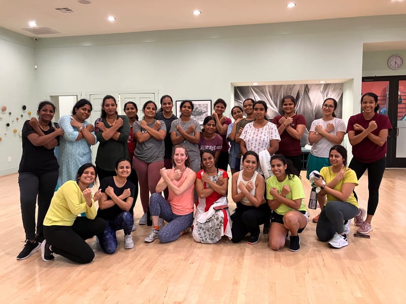 Group photo of a Bollywood dance cardio class in a dance studio